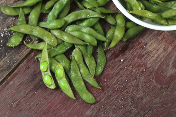 Edamame soy beans on wood background.