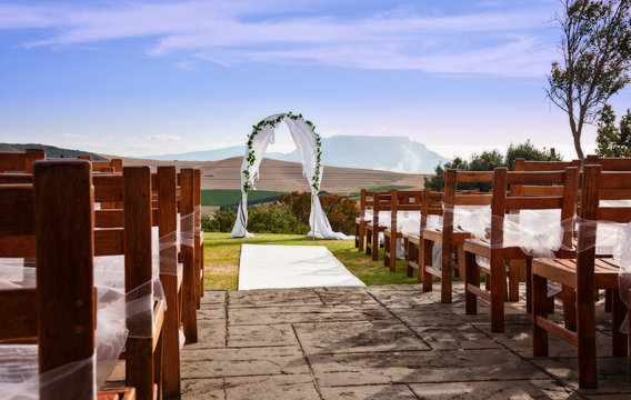a wedding arch against a outdoor landscape