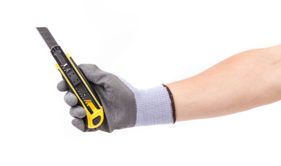 Hand in gloves holding knife. 