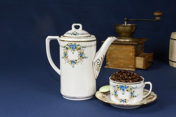 coffee mug on the table with a blue tablecloth