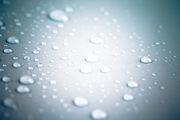 Drops of water on a color background. Toned gray. Shallow depth