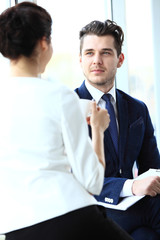 Young couple of professionals chatting during a coffee break