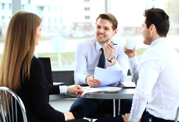 Image of business partners discussing documents and ideas