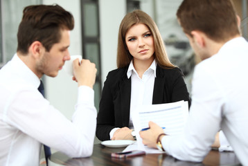 Image of business partners discussing documents and ideas