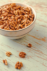 Walnut Kernels in Bowl on Rustic Wooden Background