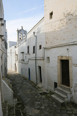 Narrow alley in the center of the medieval town Ostuni in Puglia