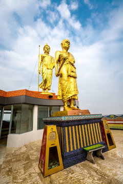 Grand Monk Image stand in front of Buddha.
