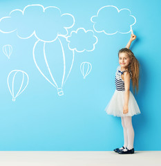 Cute girl making chalk drawings