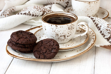 Coffee cup with  chocolate cookies  on table