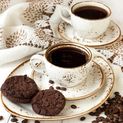 Cup of coffee with cookies and coffee beans