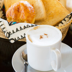 Hot Coffee with Bread in background : Selective Focus