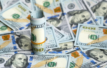 Fototapeta premium bundle of dollars in bills spilling