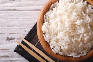 Japanese food: steamed rice in a wooden bowl top view
