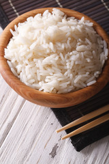 rice in a wooden bowl closeup. vertical