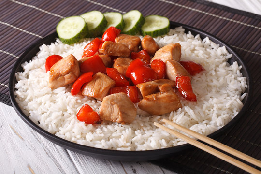 Rice with chicken pieces in a close-up of Asian style