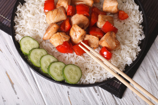 Chinese food: rice with chicken and teriyaki sauce top view
