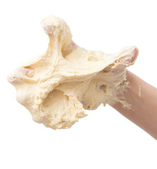 dough in hand on a white background