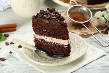Delicious chocolate cake on table on brown background