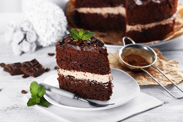Delicious chocolate cake on table on light background