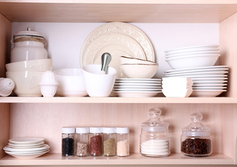 Fototapeta na wymiar Kitchen utensils and tableware on shelves