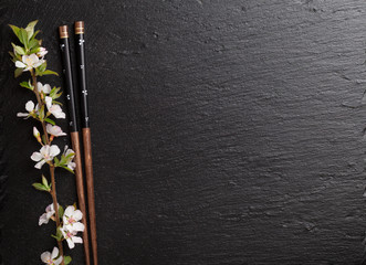 Japanese sushi chopsticks and sakura blossom