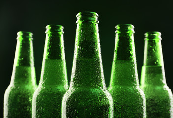 Glass bottles of beer on dark background