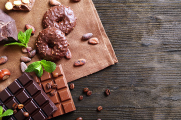 Chocolate with mint, spices and coffee beans on table, closeup