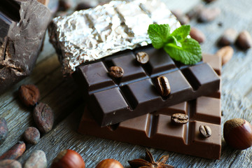 Delicious chocolate with spices on wooden table, closeup