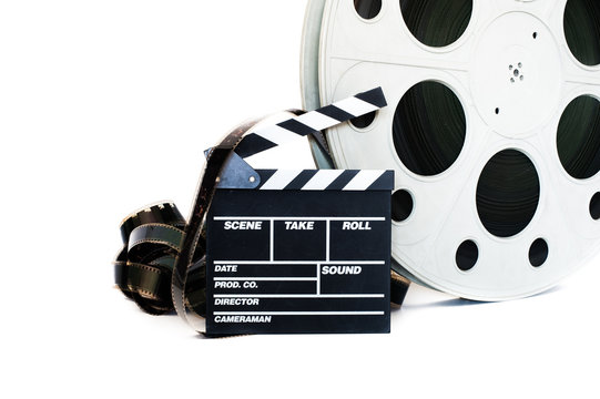 Movie clapper and vintage 35 mm film cinema reel on white