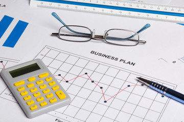 close up of business plan with and calculator