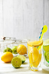 Cocktails with fresh citrus fruits on wooden background