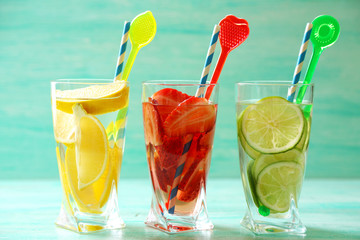 Cocktails with fresh strawberries and lemons on wooden background