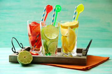 Cocktails with fresh strawberries and lemons on wooden background