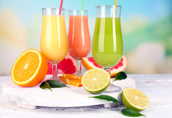 Obraz na płótnie Canvas Fresh summer cocktails on wooden table on bright blurred background