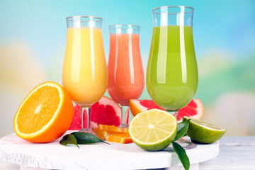 Fresh summer cocktails on wooden table on bright blurred background