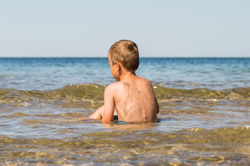 Boy playing in the ocean