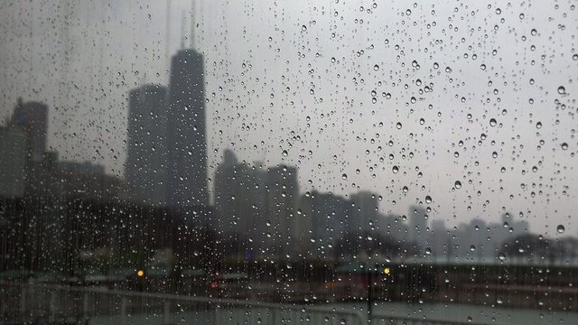 Chicago in rain from Navy Pier through glass.