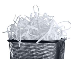 Strips of destroyed paper from shredder in trash can isolated on white