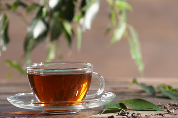 Cup of green tea on table on wooden background
