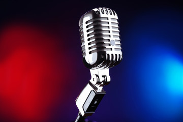 Retro microphone on colorful blurred background