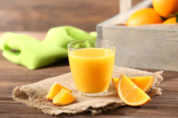 Obraz na płótnie Canvas Orange juice on table on wooden background