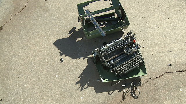 Typewriter Bounces. A typewriter being thrown onto concrete, bouncing and breaking on impact. Shot in slow motion at 60fps.