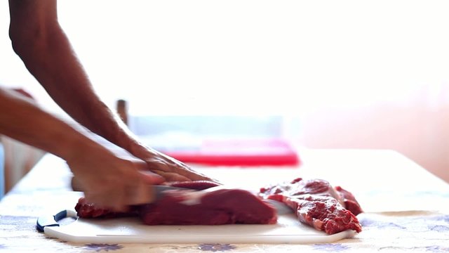 HD 1080 closeup: chef cutting beef steak onto slices