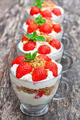 homemade desert with cream chopped cookies and fresh strawberry