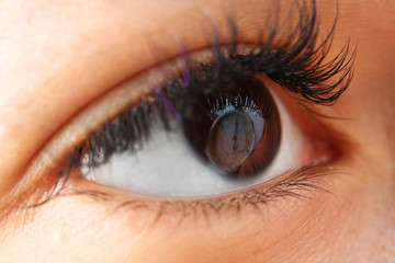 Fototapeta na wymiar Reflection clock in an eye close-up