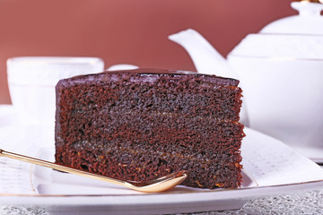 Piece of chocolate cake on white plate, closeup