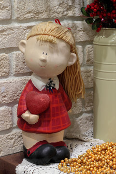 Doll with heart in a hand