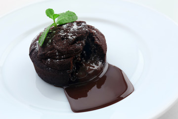Chocolate fondant on white plate, closeup