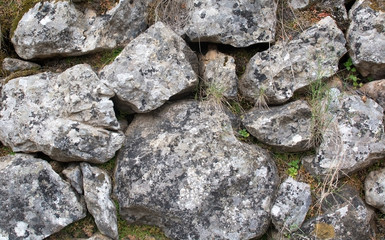 Old rocks in drystone wall outdoors, Majorca, Spain.
