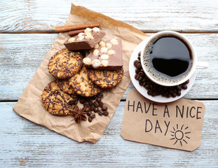 Cup of coffee with fresh croissant and Have A Nice Day massage on wooden table, top view